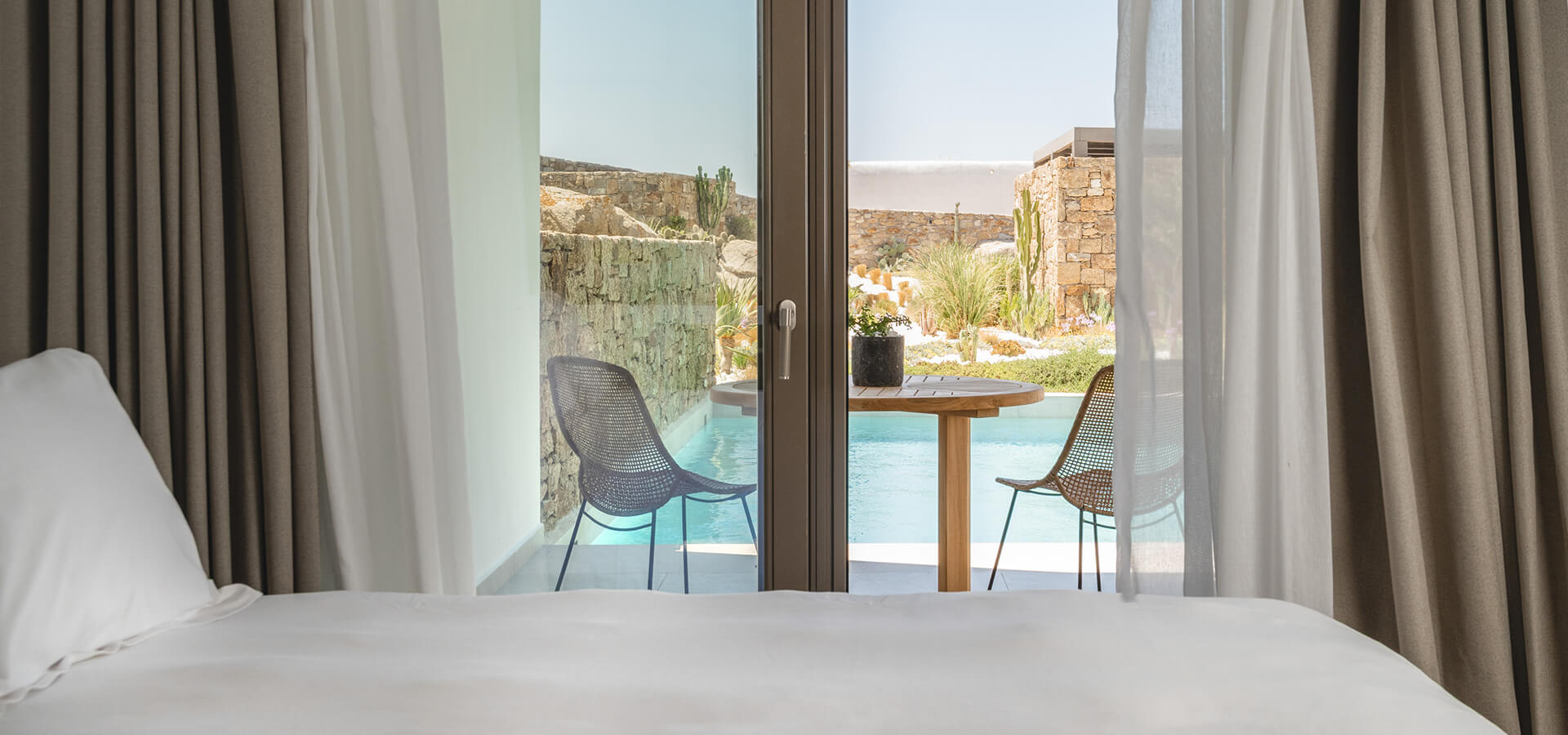 Bedroom with a pool view